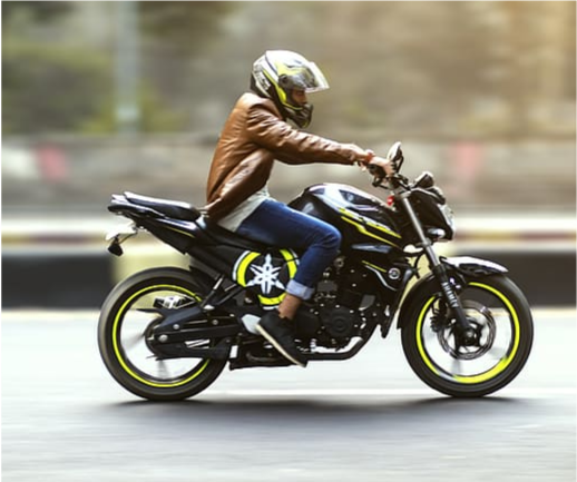 Photo of a person riding a motorcycle.